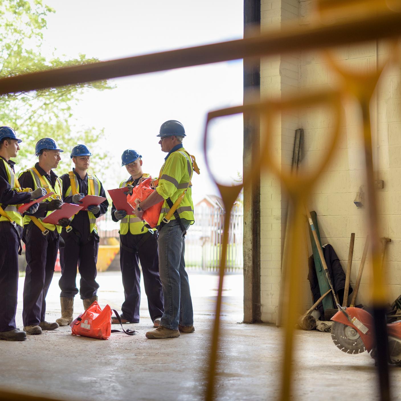 people in hard hats in discussion
