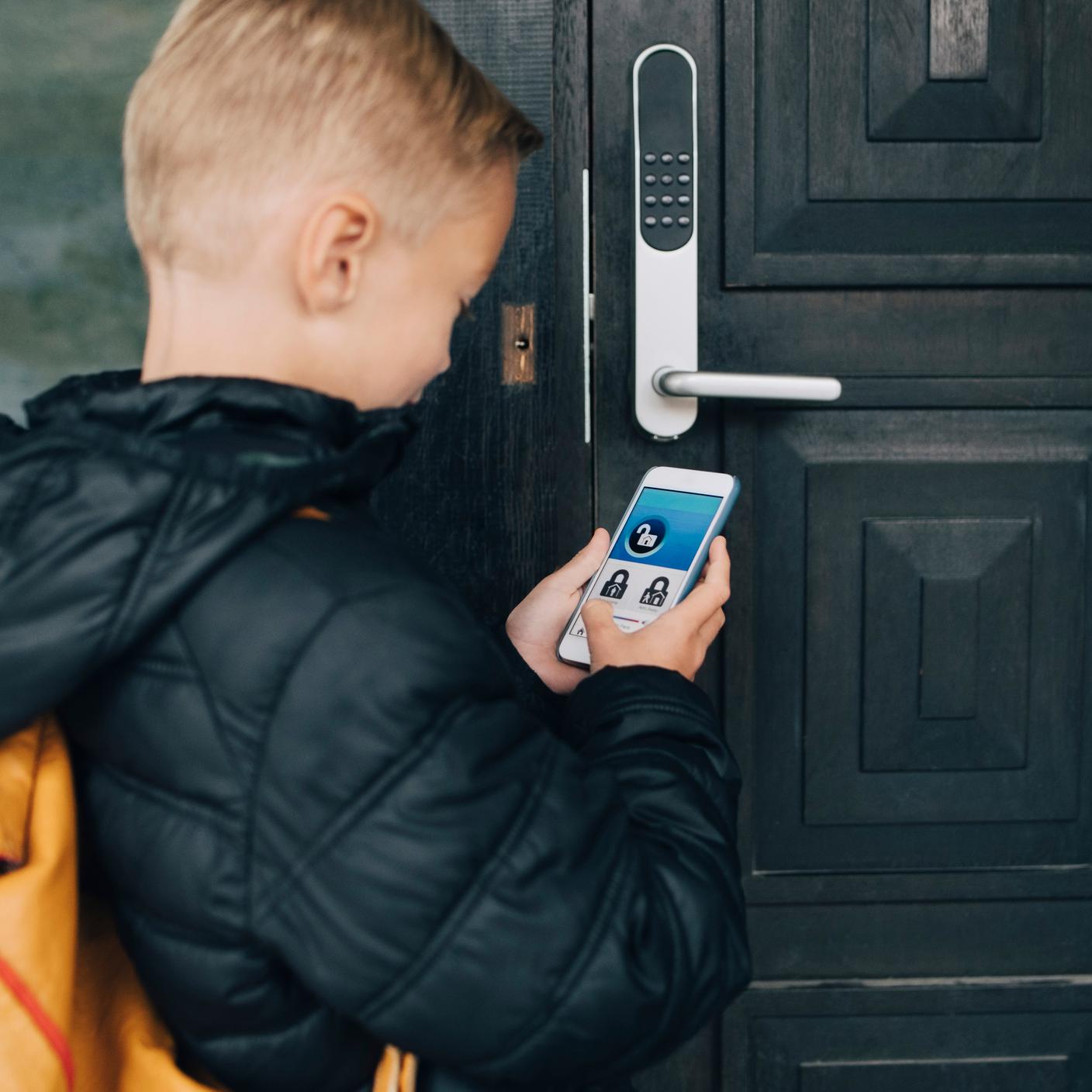 Child holding a electronic device.