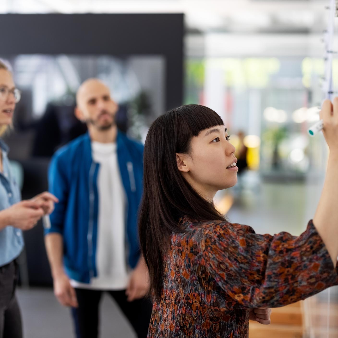 Future of trust - Young businesswoman explaining a business plan to colleague in office