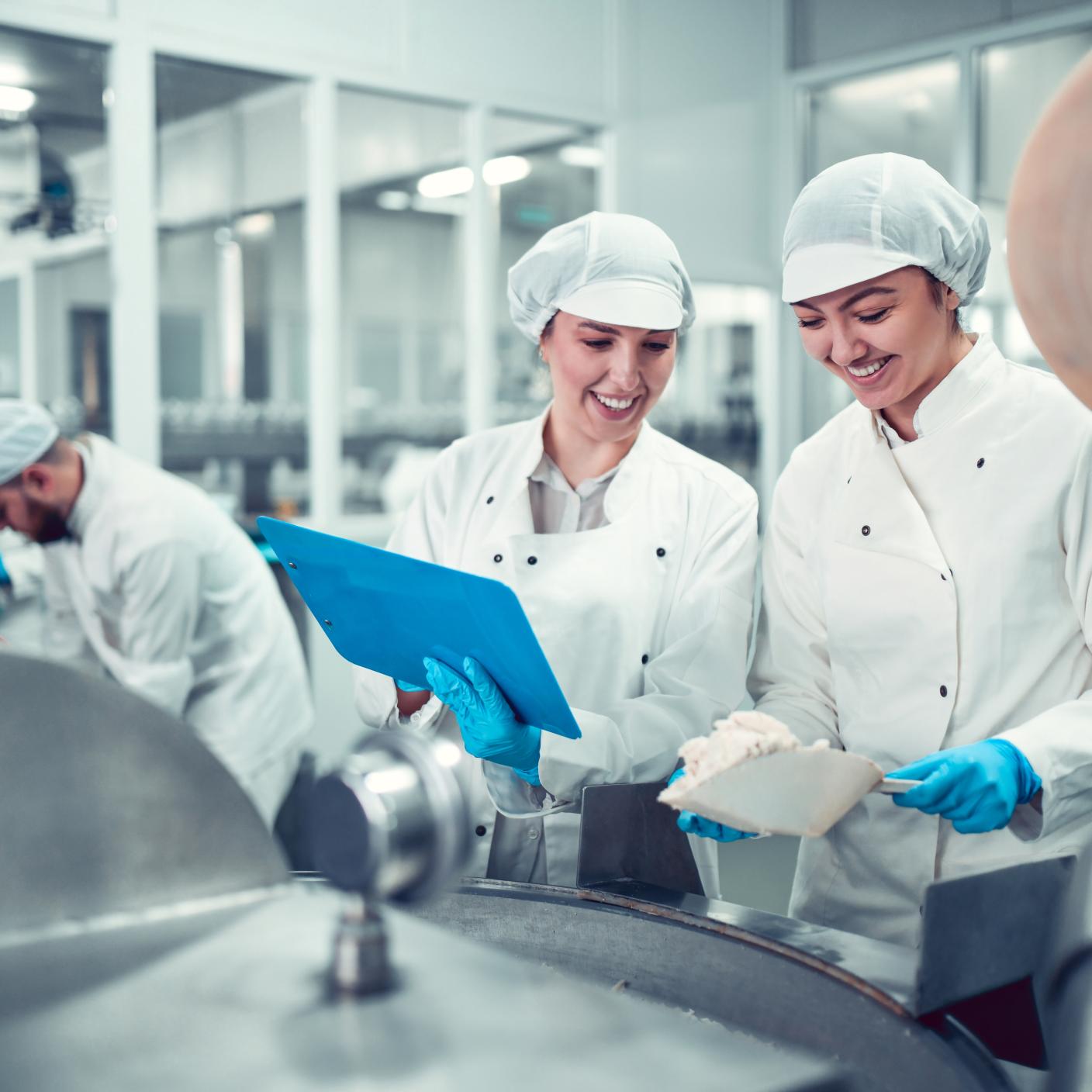 Factory Workers Filling Machine With Cottage Cheese For Stuffed Peppers In Jars.