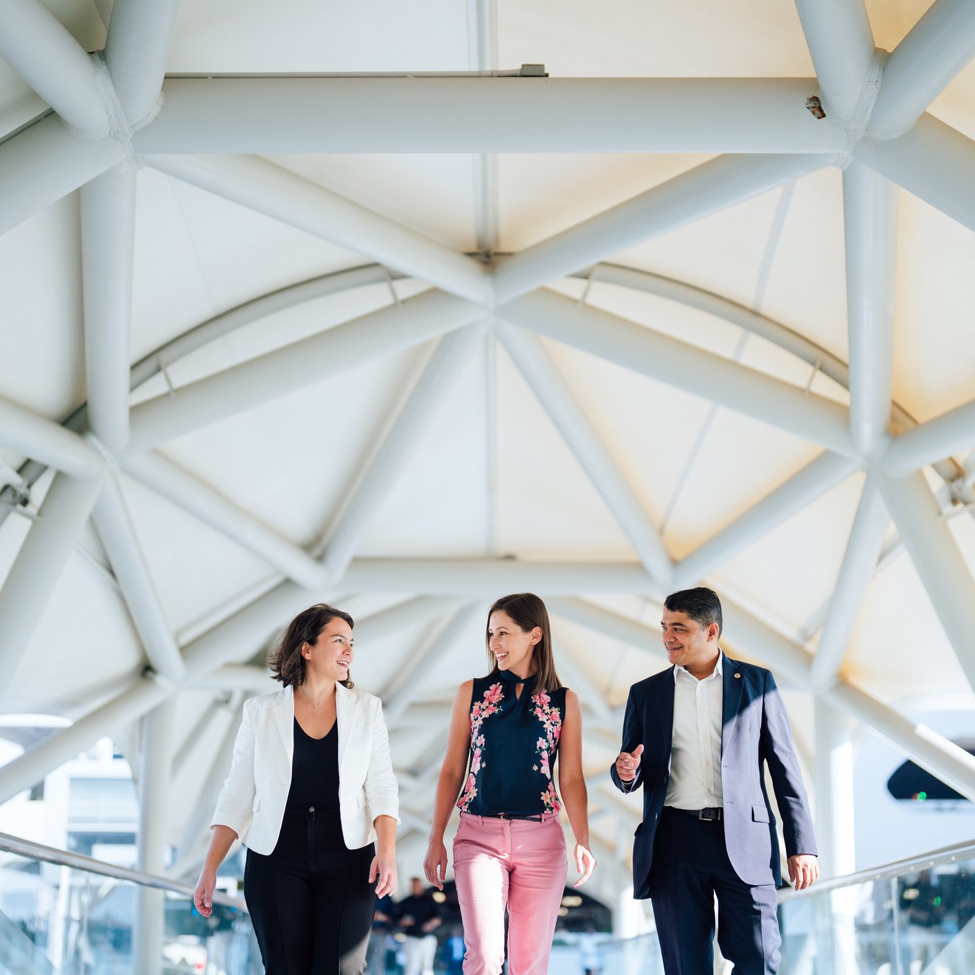Image of 3 people walking in an airport.