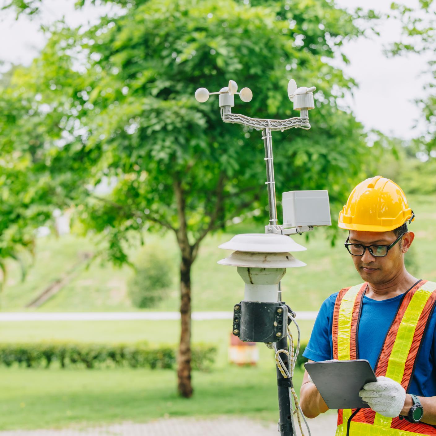 Technician male working collecting Air pollution, Weather monitor, Wind information data from sensor station outdoor