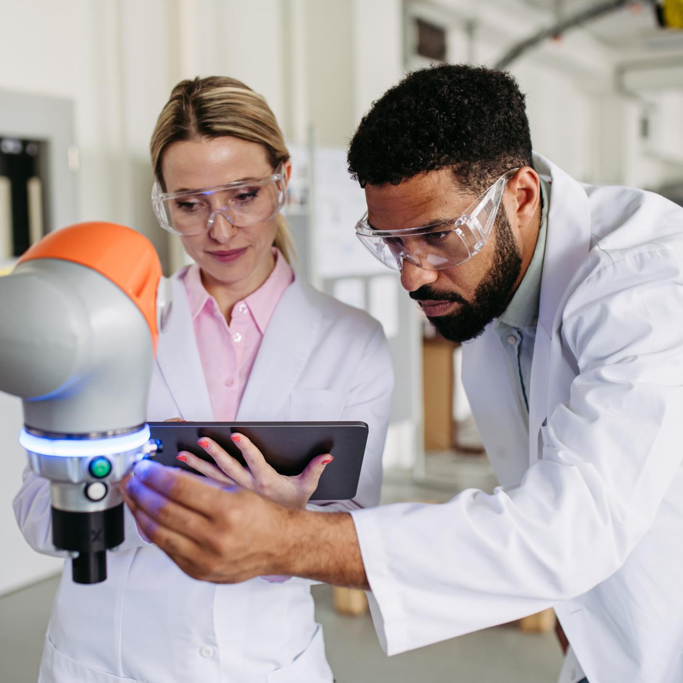 Robotic engineer colleagues working on robotic knee replacement surgery project.
