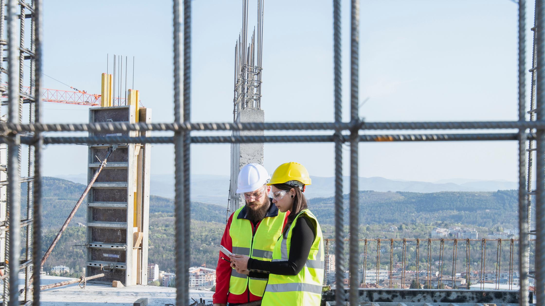 Buildings and Construction - woman and man on construction building site 