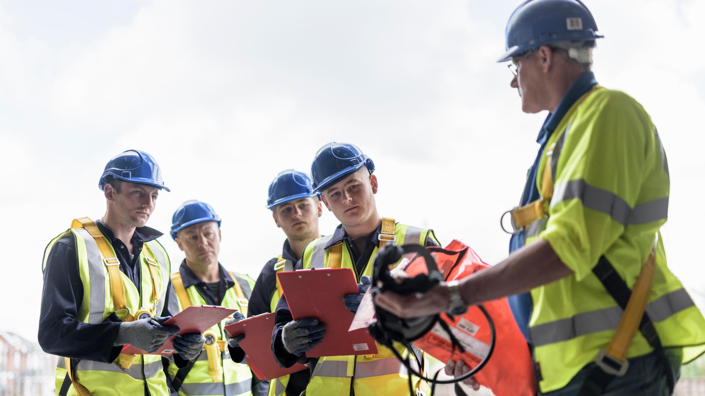 A group of construction workers having a field meeting