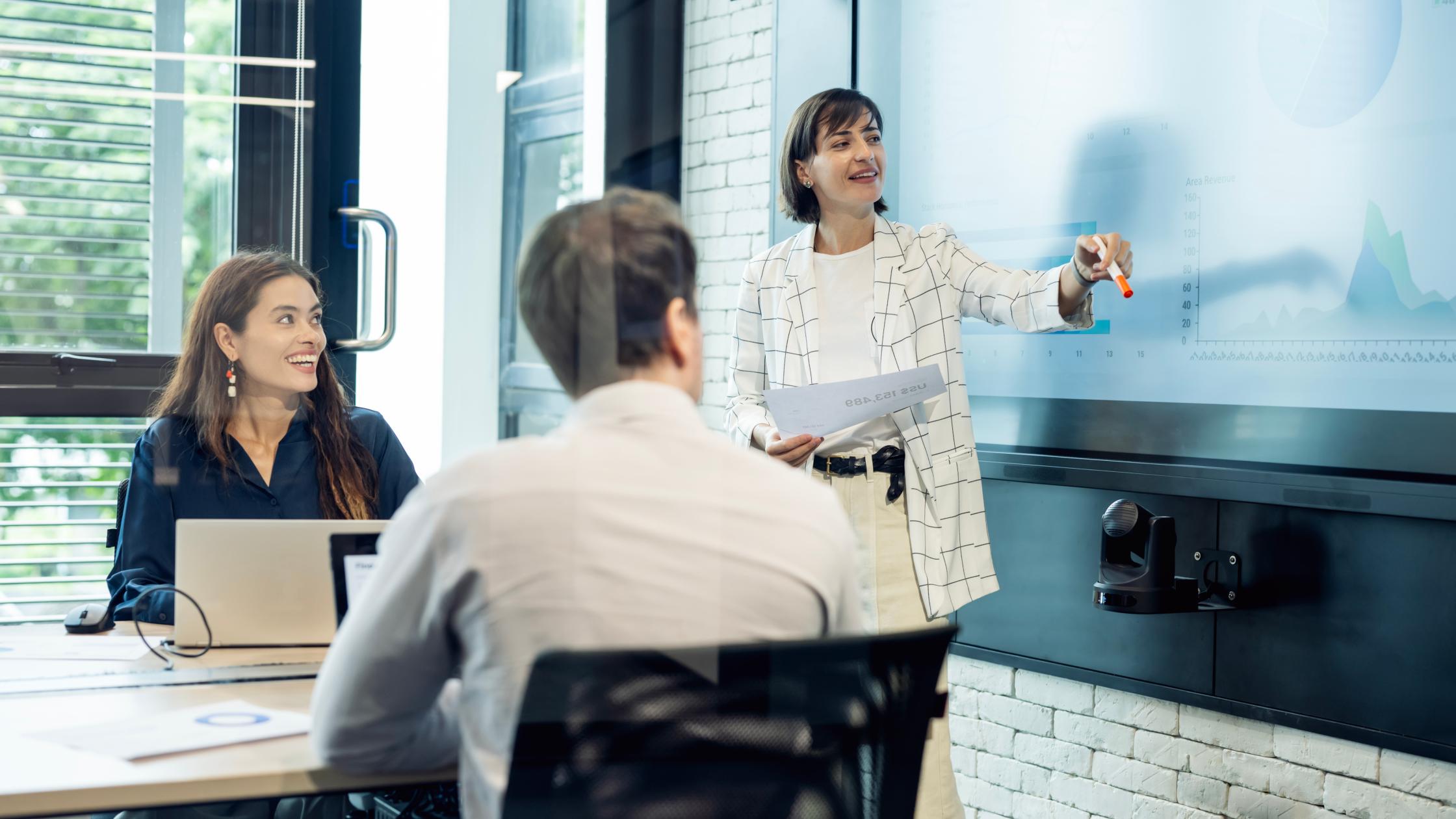 Multiple people in the office in a meeting.